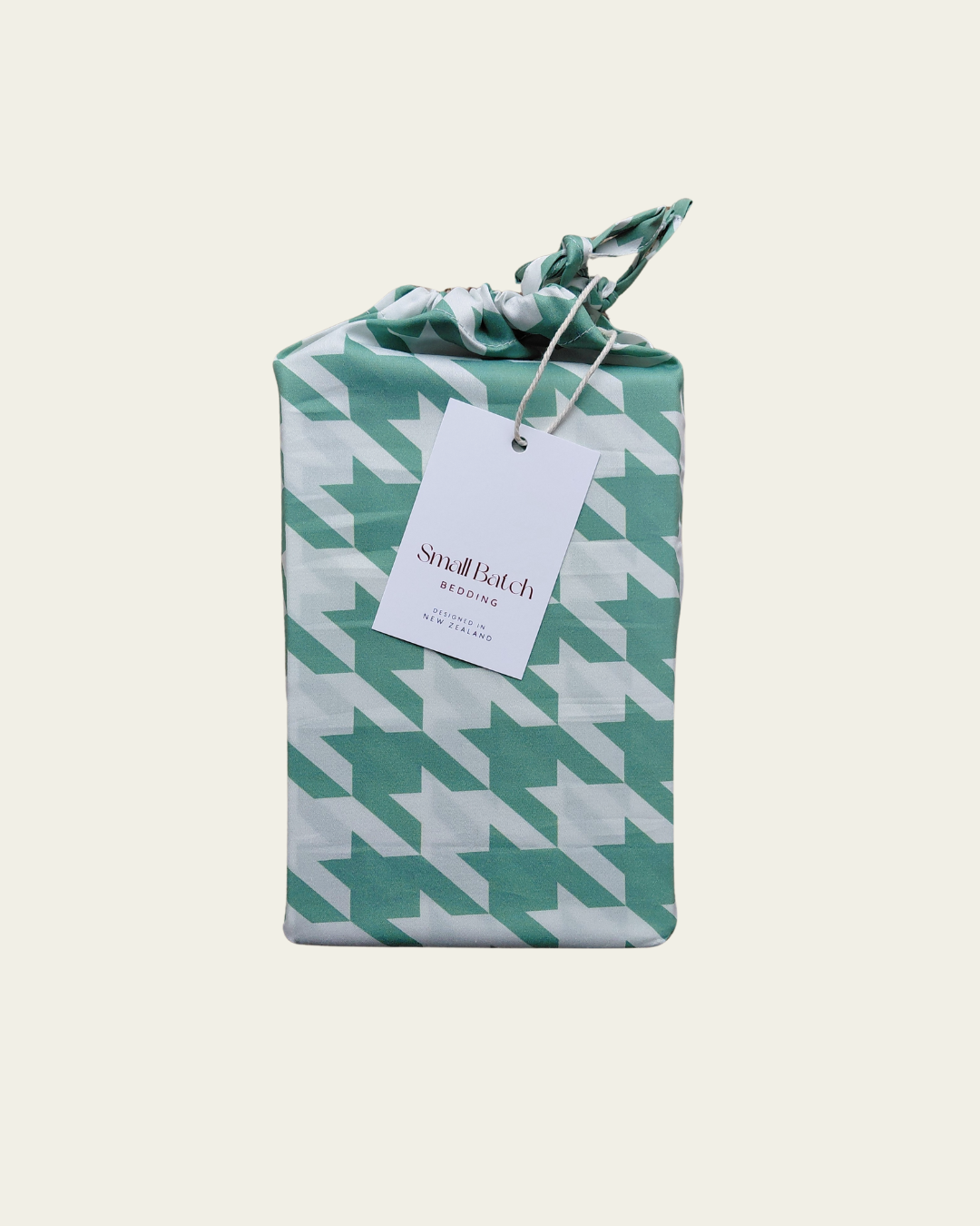 Packaged product with a green and white houndstooth pattern and a visible Small Batch Bedding brand tag on a white background.