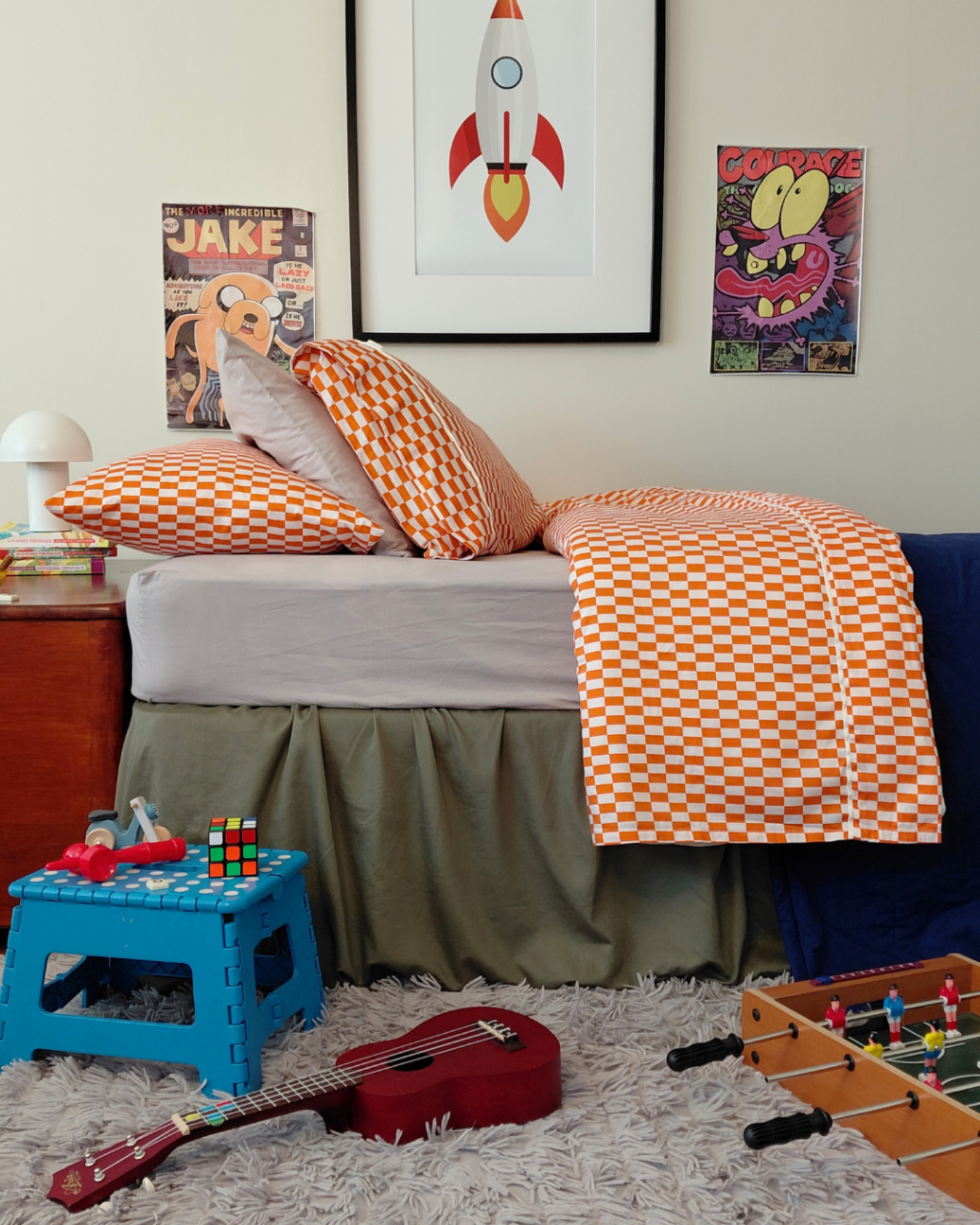 Beautiful child's bedroom featuring Red Orange Tomato Tile Pillows and Flat Sheet by Small Batch Bedding on a grey fitted sheet. Kids Bedroom cotton bedding inspo.